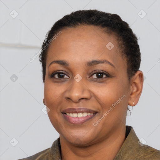 Joyful black adult female with short  black hair and brown eyes