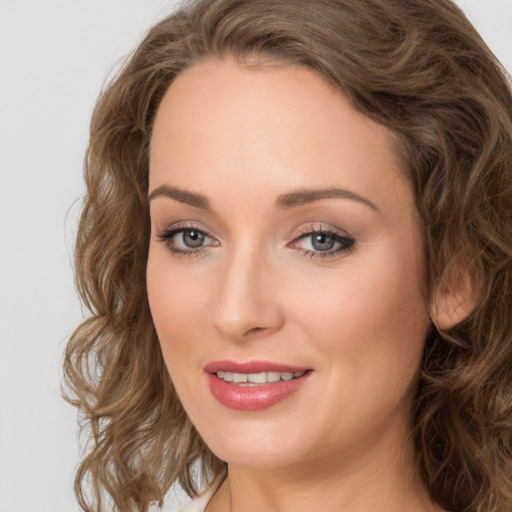 Joyful white young-adult female with long  brown hair and green eyes