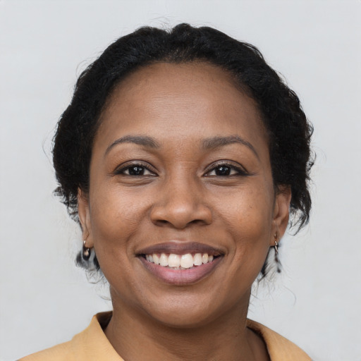 Joyful black young-adult female with medium  brown hair and brown eyes