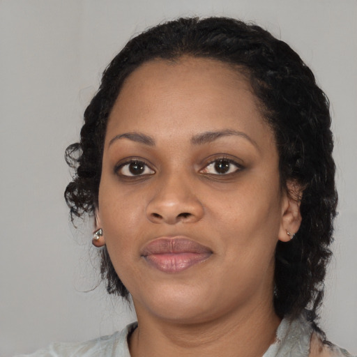 Joyful black young-adult female with medium  black hair and brown eyes