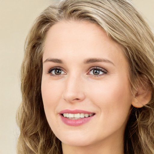 Joyful white young-adult female with long  brown hair and green eyes