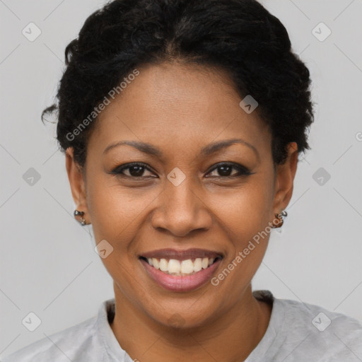 Joyful black young-adult female with short  black hair and brown eyes