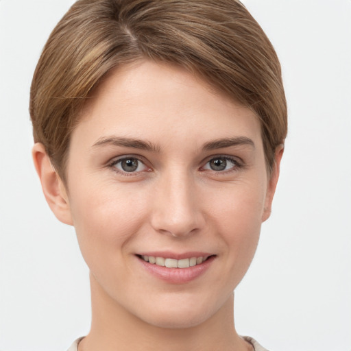 Joyful white young-adult female with short  brown hair and grey eyes