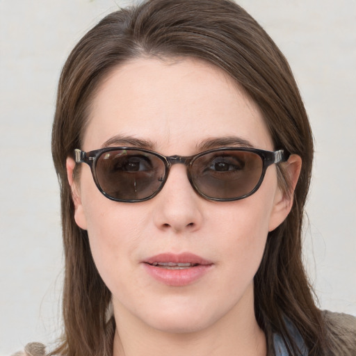 Joyful white young-adult female with medium  brown hair and blue eyes