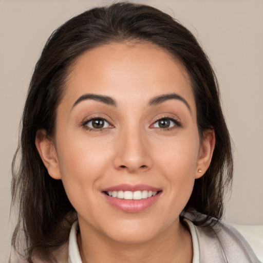 Joyful white young-adult female with medium  brown hair and brown eyes