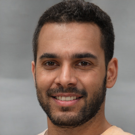 Joyful white young-adult male with short  black hair and brown eyes