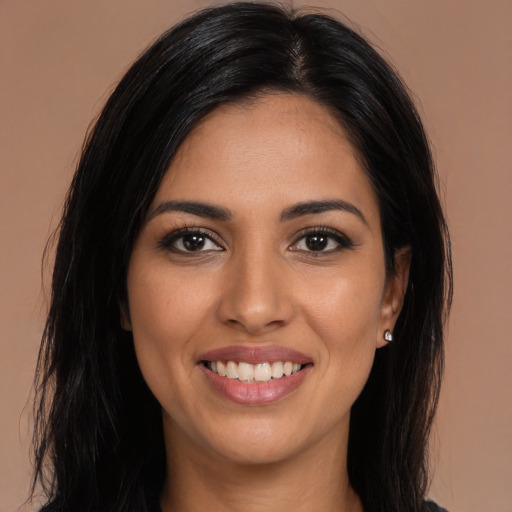 Joyful latino young-adult female with long  brown hair and brown eyes