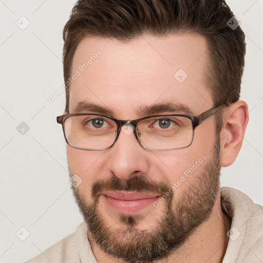 Joyful white adult male with short  brown hair and brown eyes