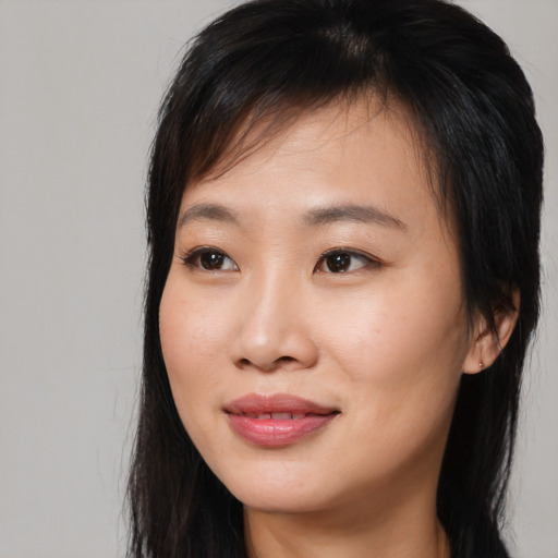 Joyful asian young-adult female with long  brown hair and brown eyes