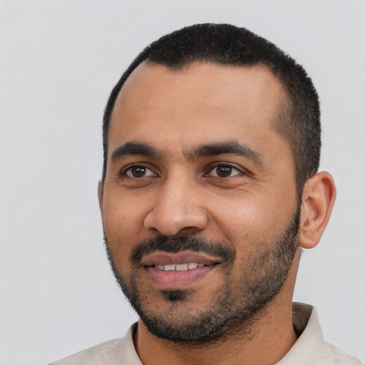 Joyful latino young-adult male with short  black hair and brown eyes