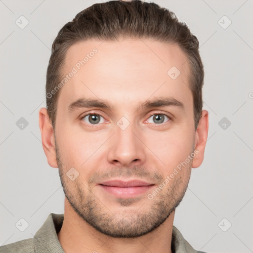 Joyful white young-adult male with short  brown hair and grey eyes