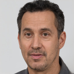 Joyful white adult male with short  black hair and brown eyes
