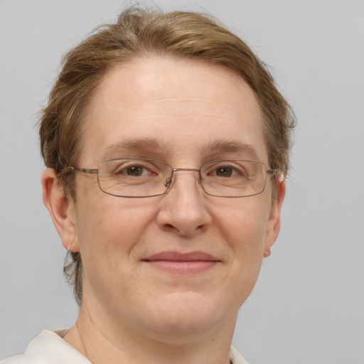 Joyful white adult female with short  brown hair and blue eyes