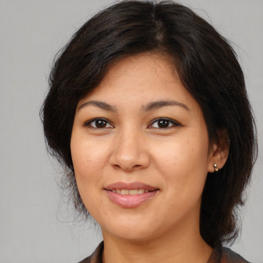 Joyful white young-adult female with medium  brown hair and brown eyes