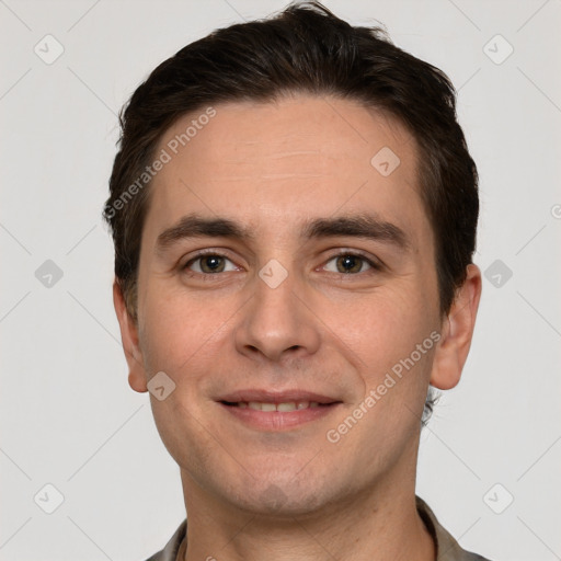 Joyful white young-adult male with short  brown hair and grey eyes