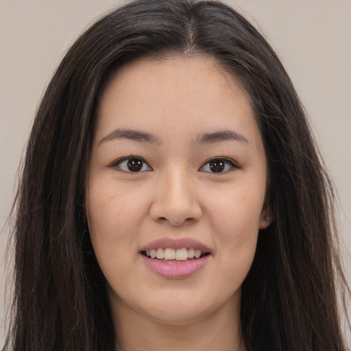 Joyful asian young-adult female with long  brown hair and brown eyes