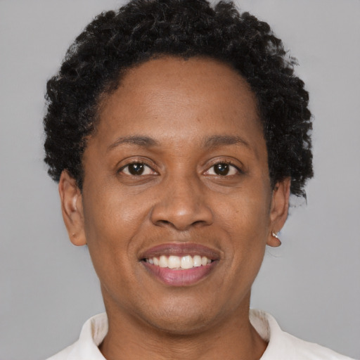 Joyful black adult female with short  brown hair and brown eyes