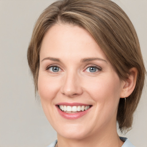 Joyful white young-adult female with medium  brown hair and green eyes