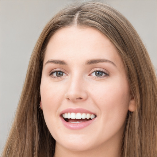 Joyful white young-adult female with long  brown hair and grey eyes