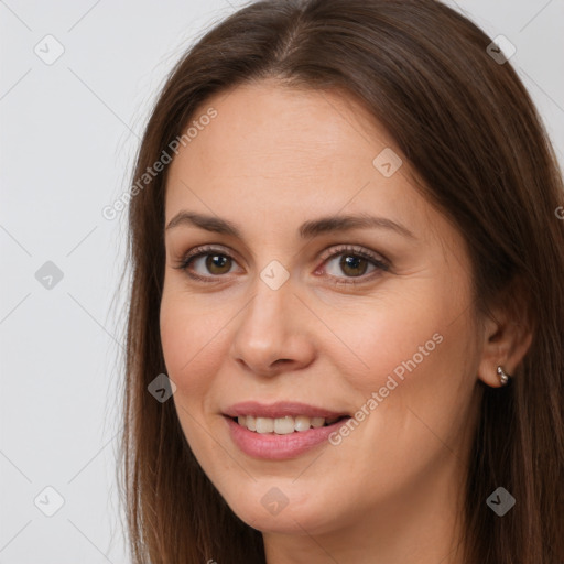 Joyful white young-adult female with long  brown hair and brown eyes