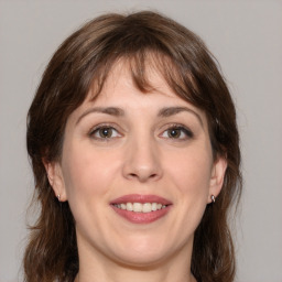 Joyful white young-adult female with medium  brown hair and grey eyes