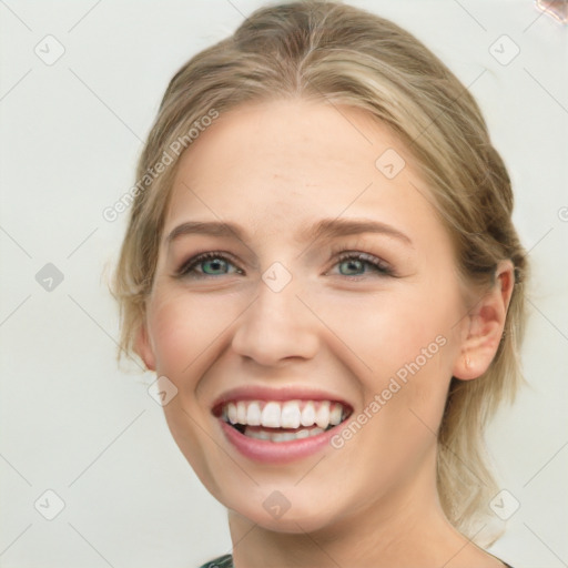 Joyful white young-adult female with medium  brown hair and green eyes