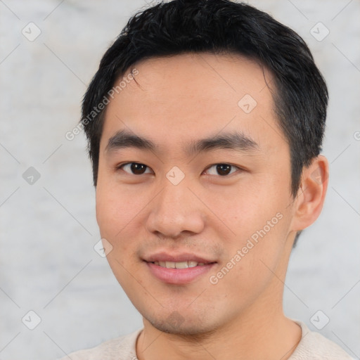 Joyful asian young-adult male with short  black hair and brown eyes