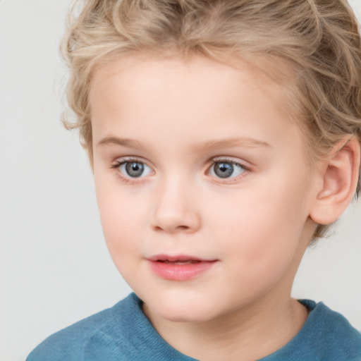 Joyful white child female with short  brown hair and blue eyes