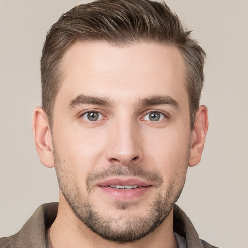 Joyful white young-adult male with short  brown hair and grey eyes