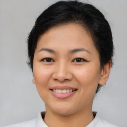 Joyful asian young-adult female with short  brown hair and brown eyes