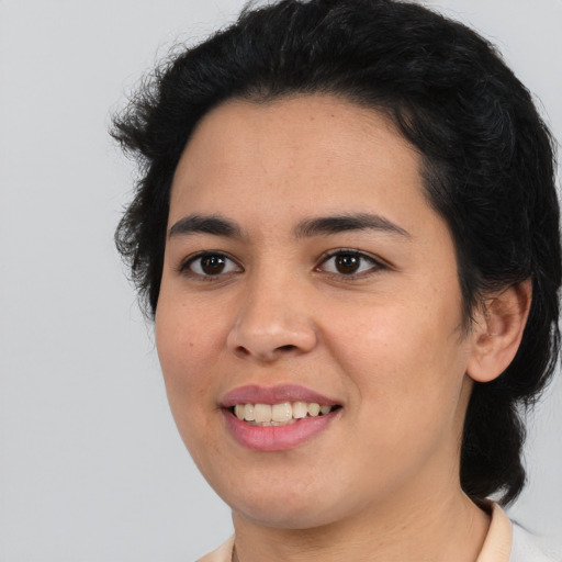 Joyful white young-adult female with medium  black hair and brown eyes