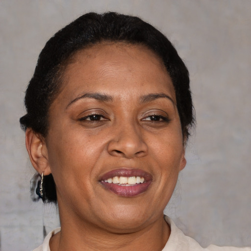 Joyful latino adult female with short  brown hair and brown eyes