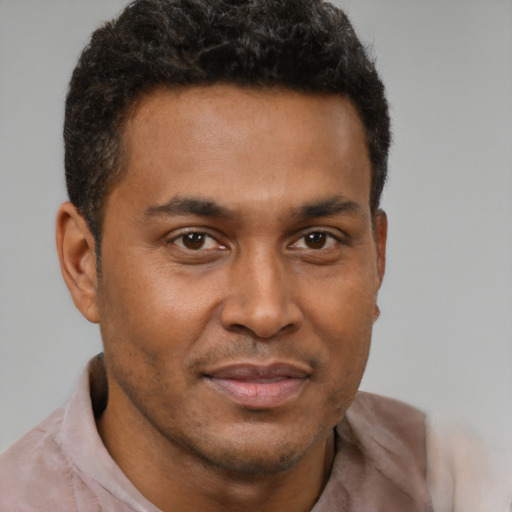 Joyful latino adult male with short  brown hair and brown eyes
