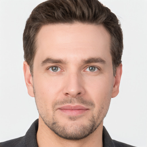 Joyful white young-adult male with short  brown hair and grey eyes