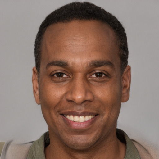 Joyful latino adult male with short  brown hair and brown eyes