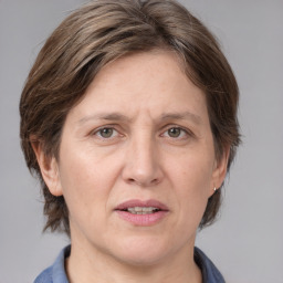 Joyful white adult female with medium  brown hair and grey eyes