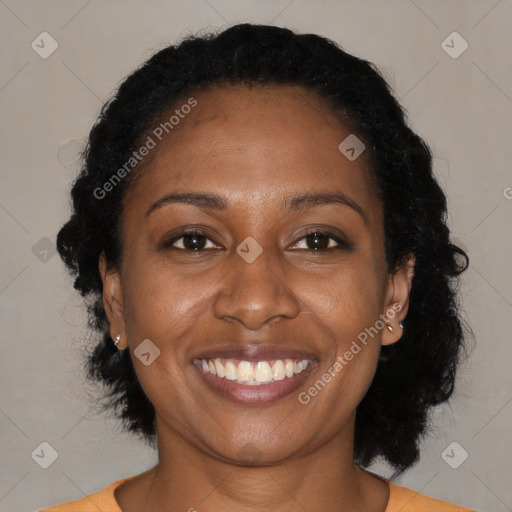 Joyful black adult female with medium  brown hair and brown eyes