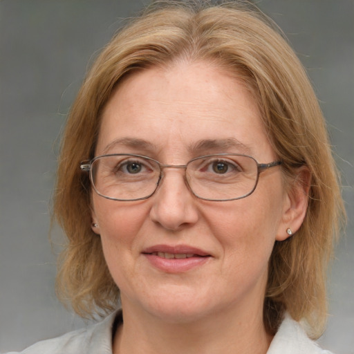 Joyful white middle-aged female with medium  brown hair and blue eyes