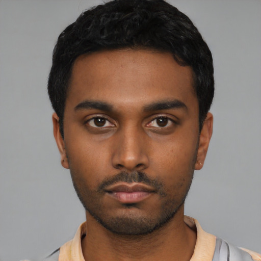 Neutral latino young-adult male with short  black hair and brown eyes