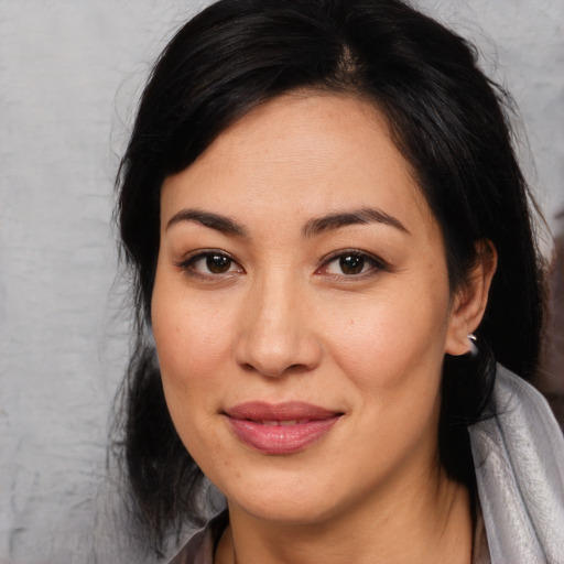 Joyful asian young-adult female with medium  black hair and brown eyes