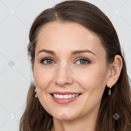 Joyful white young-adult female with long  brown hair and grey eyes