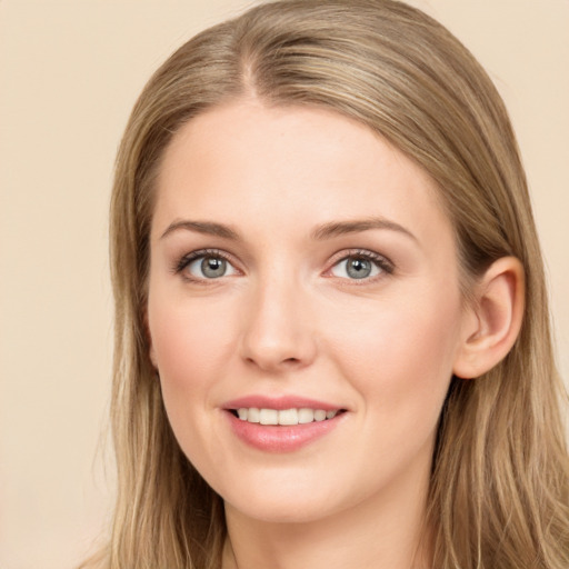 Joyful white young-adult female with long  brown hair and grey eyes