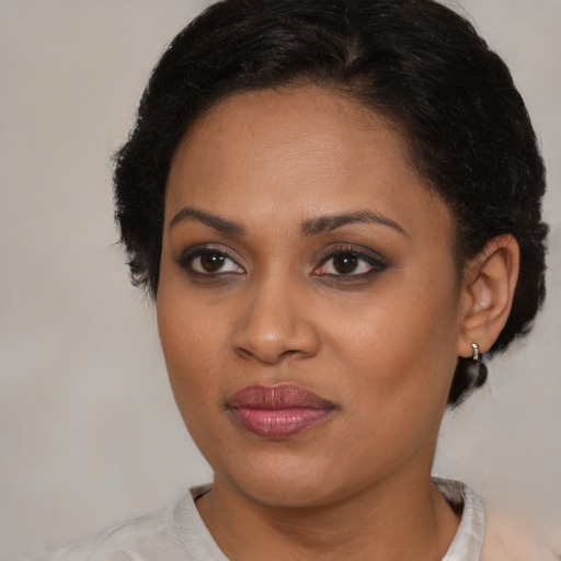 Joyful black young-adult female with medium  brown hair and brown eyes