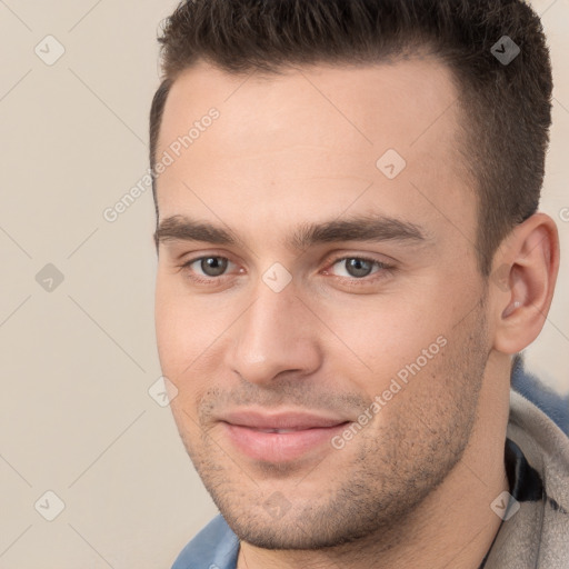 Joyful white young-adult male with short  brown hair and brown eyes