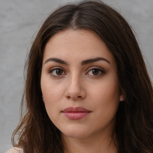 Neutral white young-adult female with long  brown hair and brown eyes