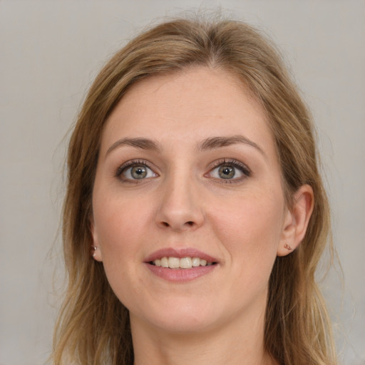 Joyful white young-adult female with long  brown hair and grey eyes