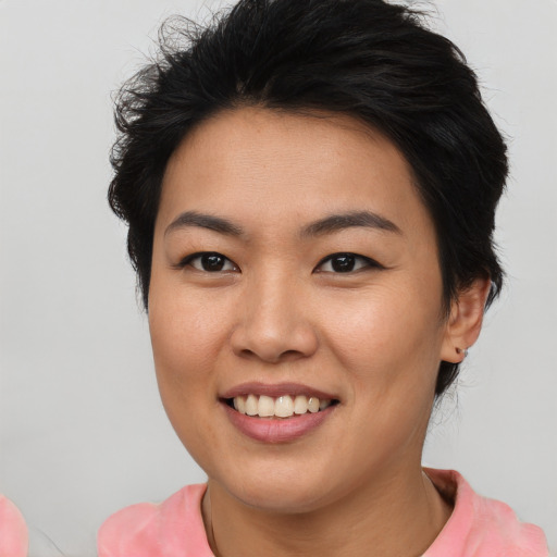 Joyful asian young-adult female with short  brown hair and brown eyes