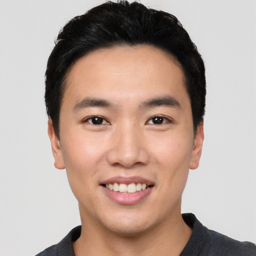 Joyful white young-adult male with short  black hair and brown eyes