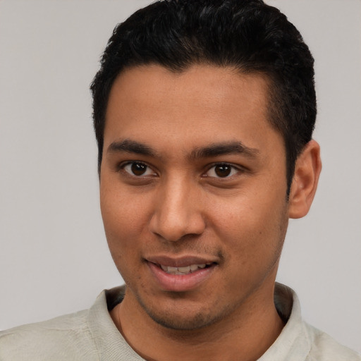 Joyful latino young-adult male with short  black hair and brown eyes