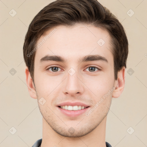 Joyful white young-adult male with short  brown hair and grey eyes